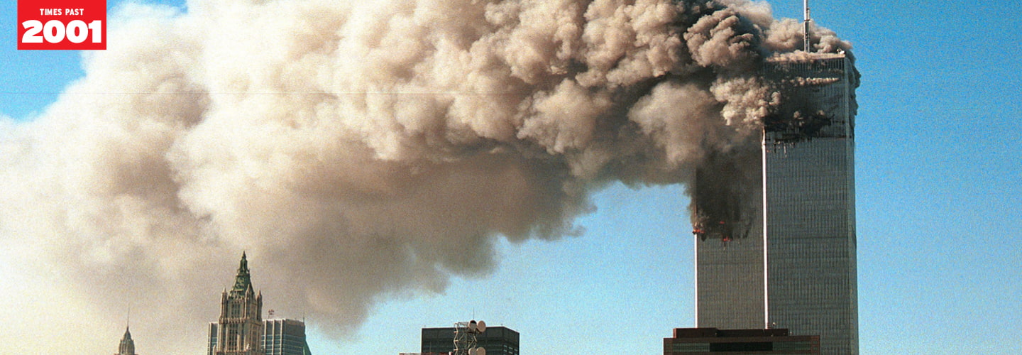 Large plume of smoke billowing out of the top of building covering most of the sky